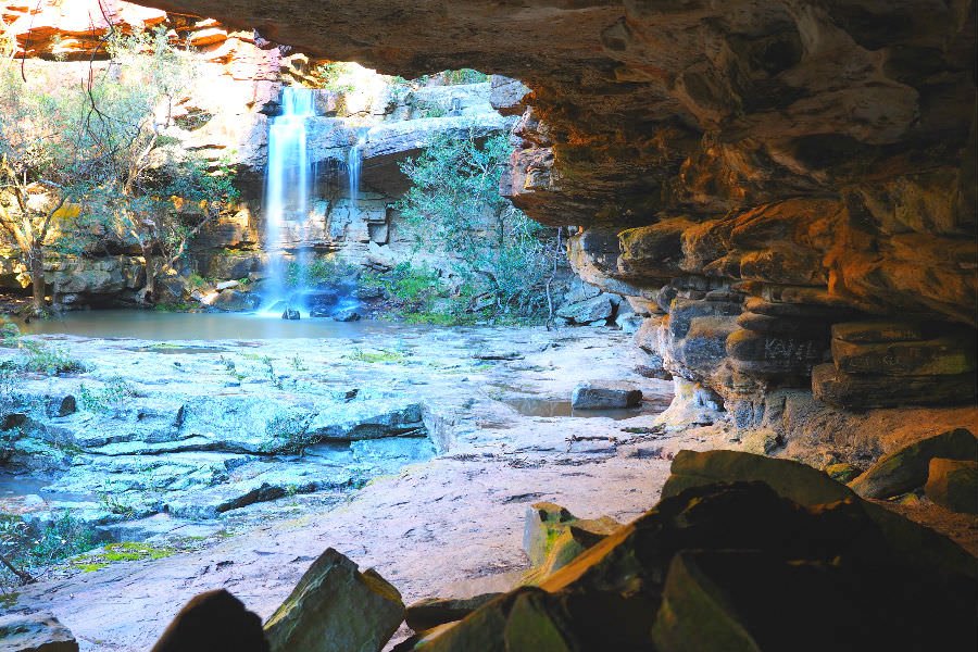 Looking out at the main falls from a shallow cave at the Deadcock Den.